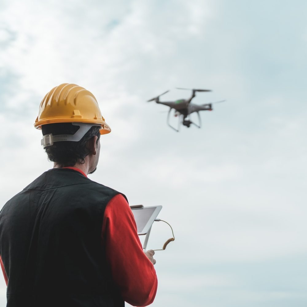 male-engineer-monitoring-construction-site-with-drone-technology-and-industrial-concept.jpg